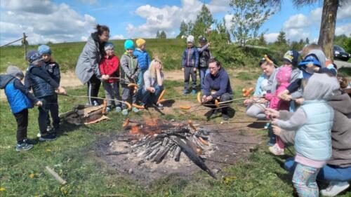 Piknik na szczycie Łapszanki. Dzieci bawią się na łące, pieką kiełbaski i śpiewają piosenki przy akompaniamencie gitary